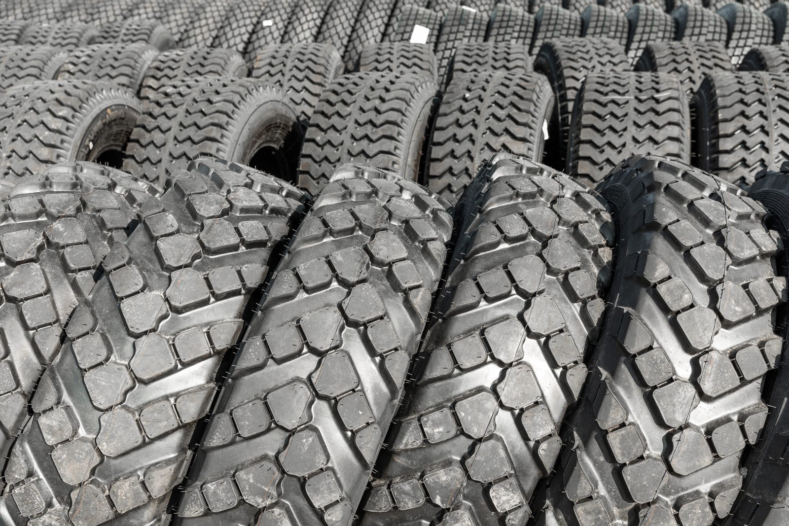 Photo of black big tires on wheels for large cars.